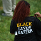 A woman wearing a shirt with “Black Lives Matter” on Aug. 9, 2015, at the Canfield Apartments in Ferguson, Mo., during a memorial service for Michael Brown Jr.
Michael B. Thomas/AFP/Getty Images